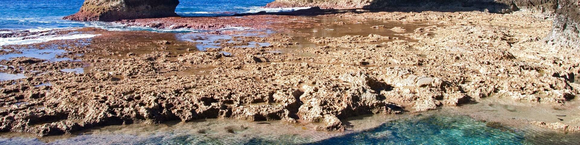 Talava Arches featuring rocky coastline