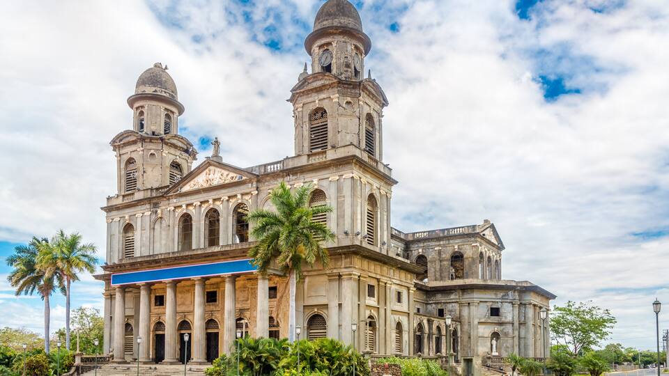 A historic church with two domes and a bell tower.