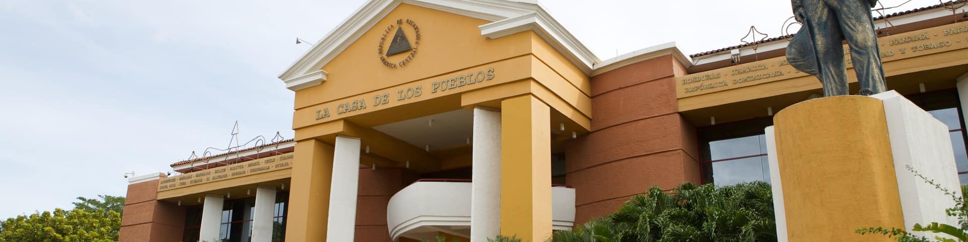 A building with a statue in front.