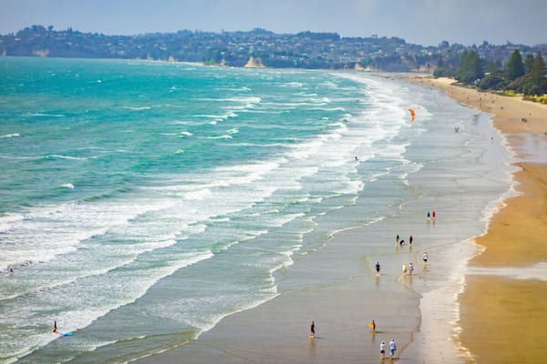 Orewa Beach which includes general coastal views, a sandy beach and landscape views