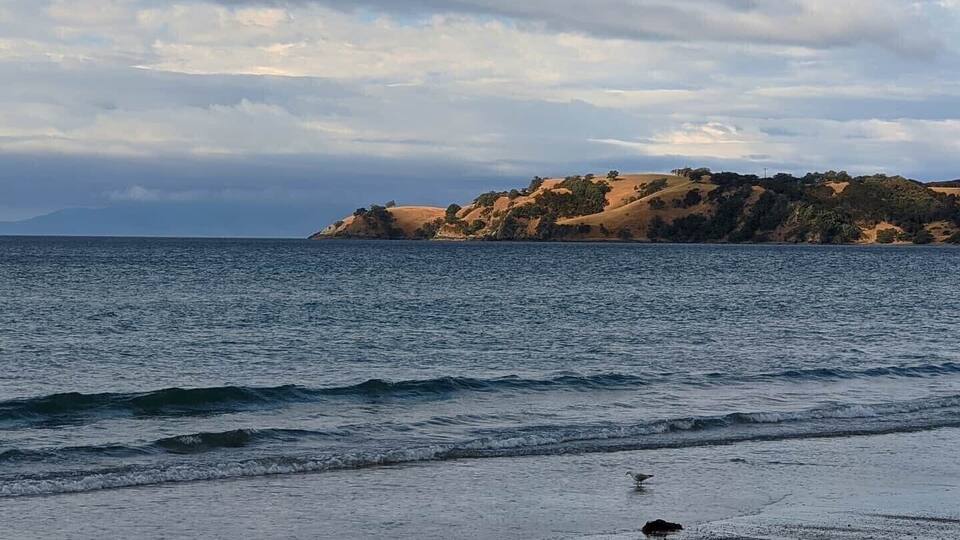 Beautiful, long, sandy beach. Was great for a swim on a hot day. Quiet beach, in crowded. Lovely light on the hills at the end of the beach.