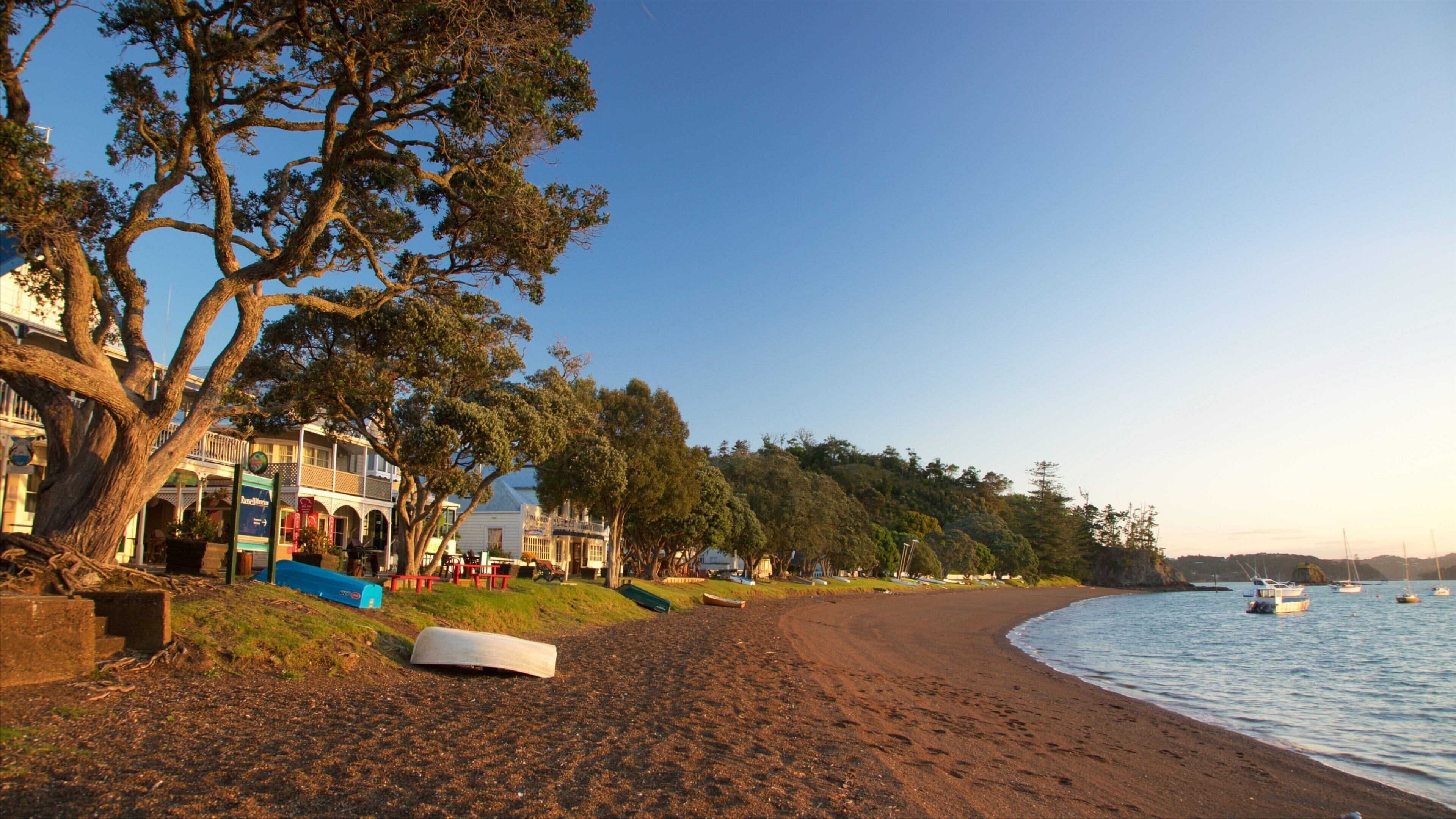 Russell Beach featuring a bay or harbour, a sandy beach and a coastal town