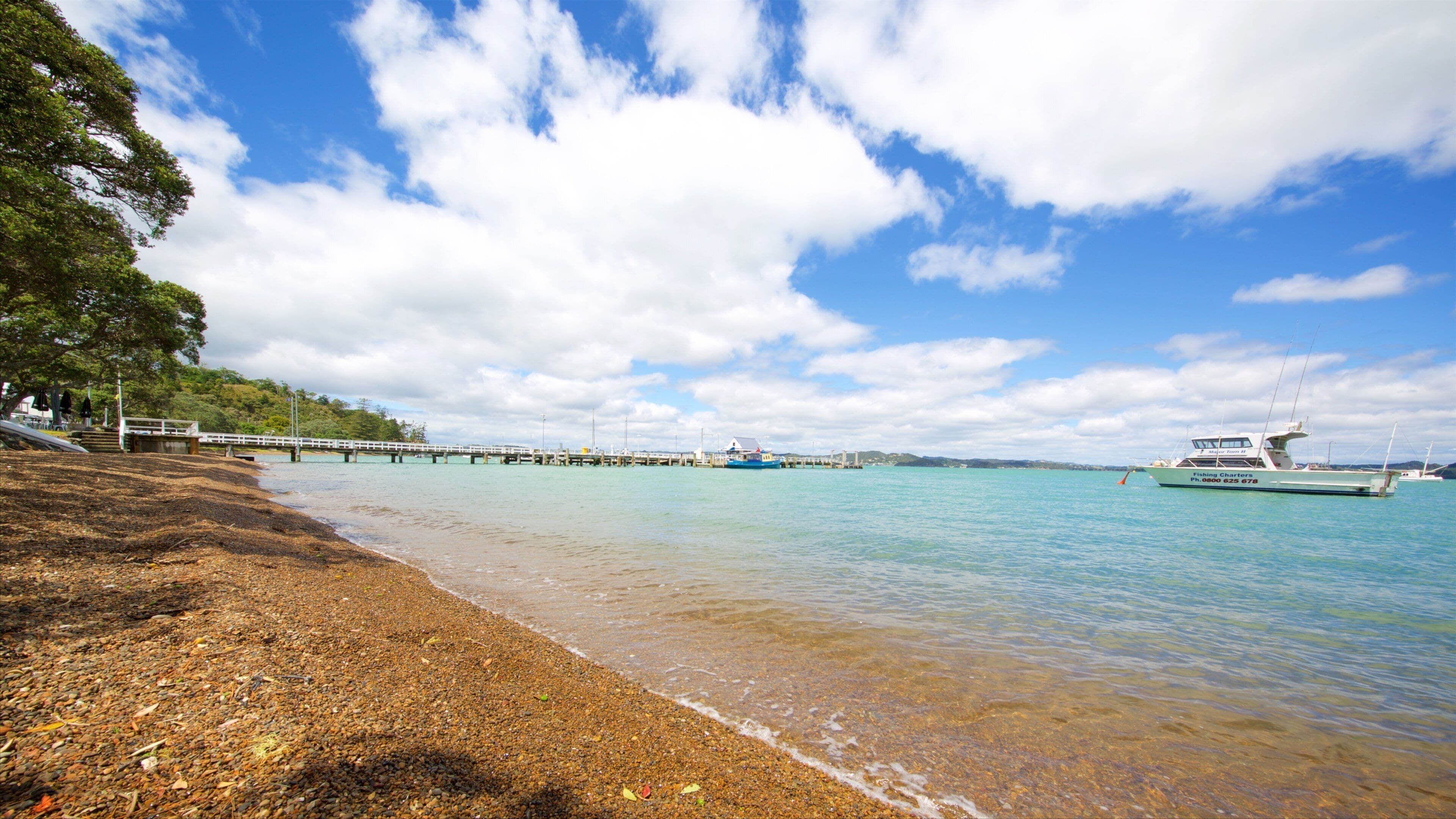 Russell Beach featuring a pebble beach and a bay or harbour