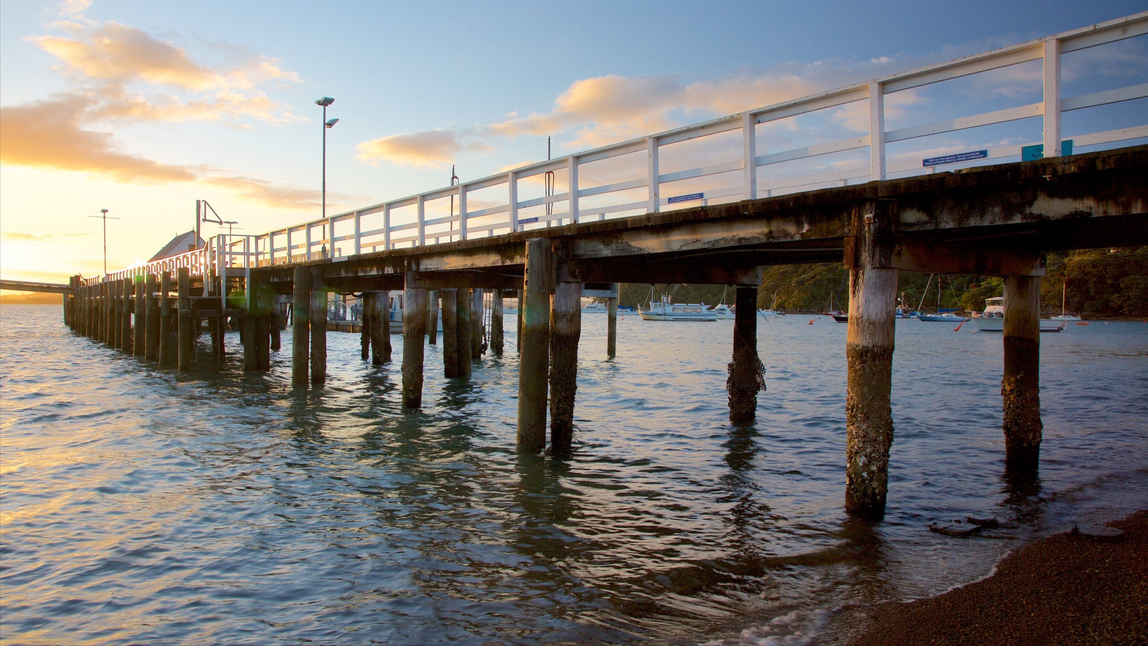 Russell Beach which includes a sunset and a bay or harbor