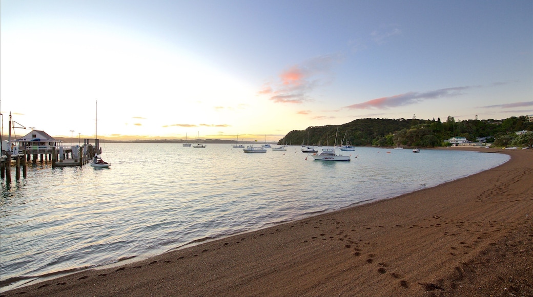 Russell Beach which includes a pebble beach, a bay or harbor and a sunset