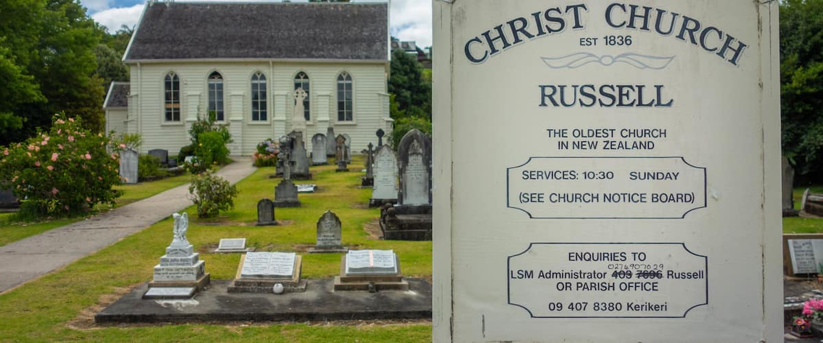 Russell Christ Church featuring signage, a cemetery and a church or cathedral