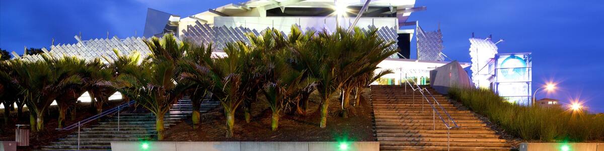 Puke Ariki which includes modern architecture and night scenes