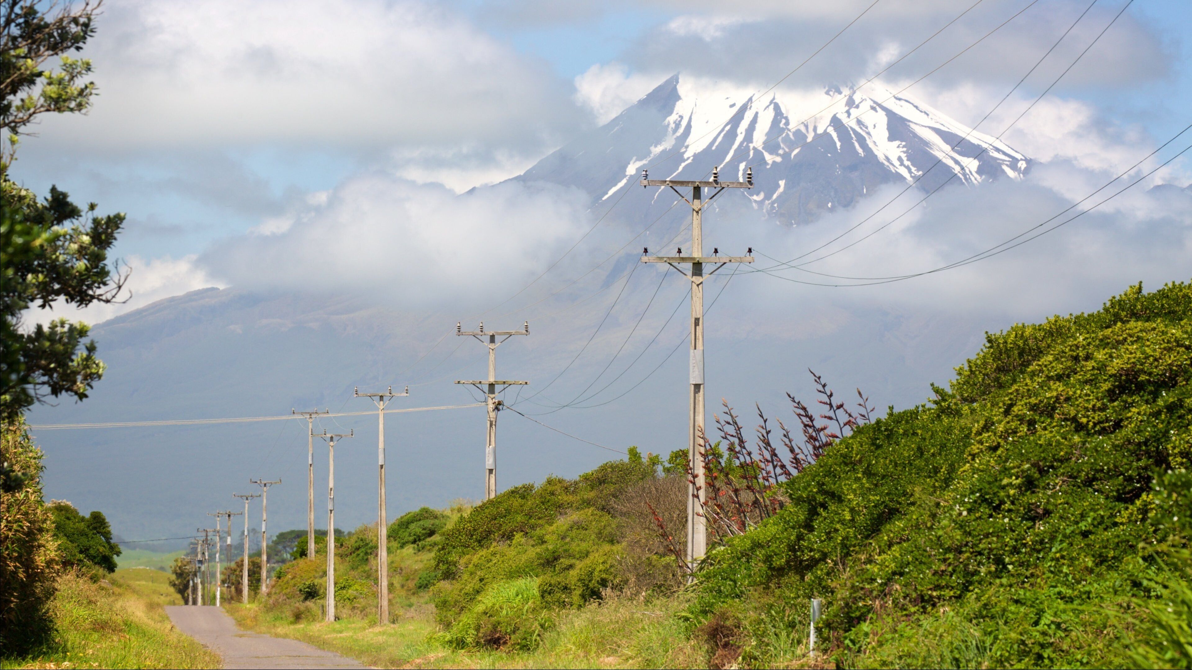 Cape Egmont Lighthouse featuring mountains and tranquil scenes