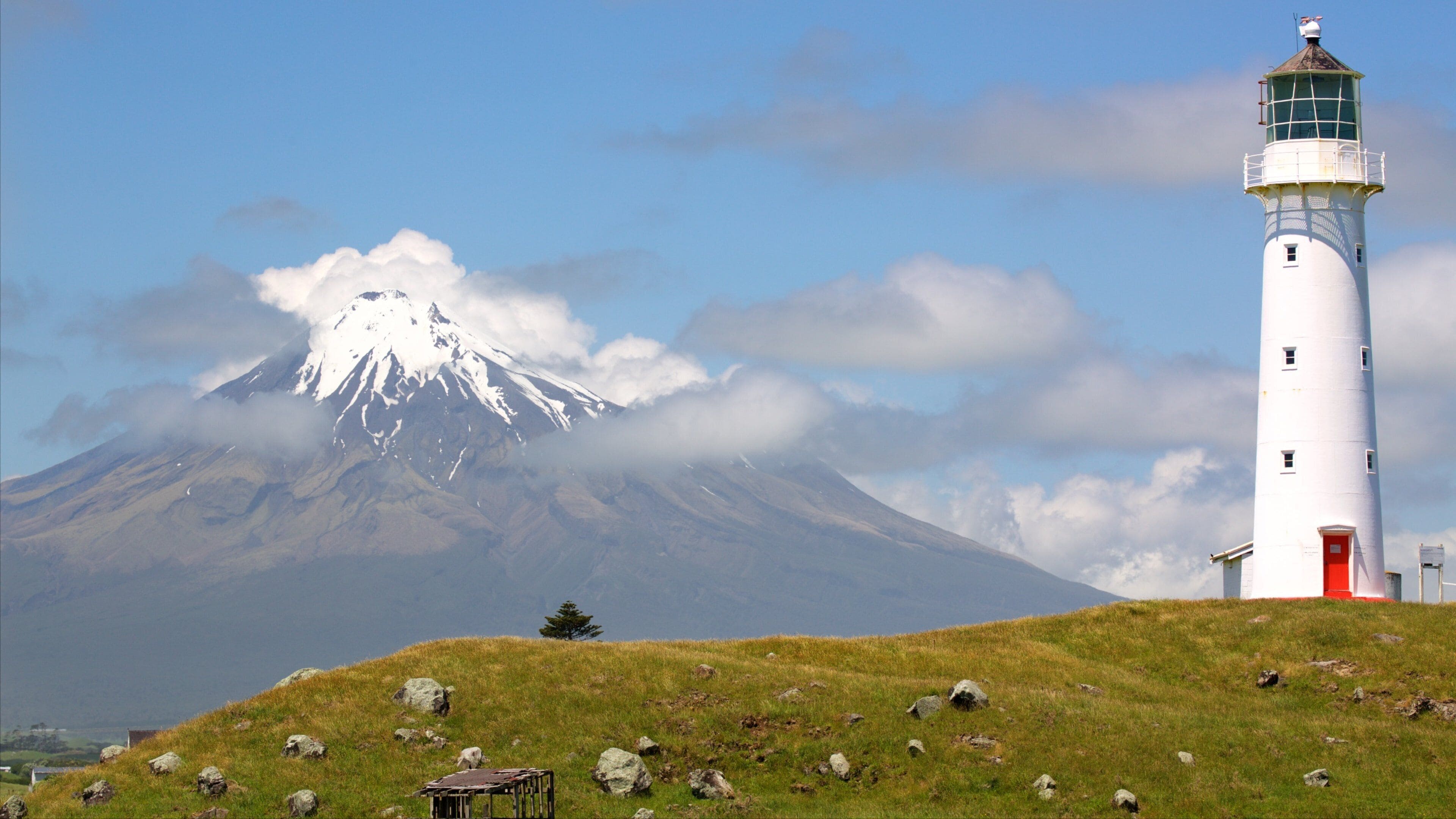 Cape Egmont Lighthouse which includes mountains, tranquil scenes and a lighthouse