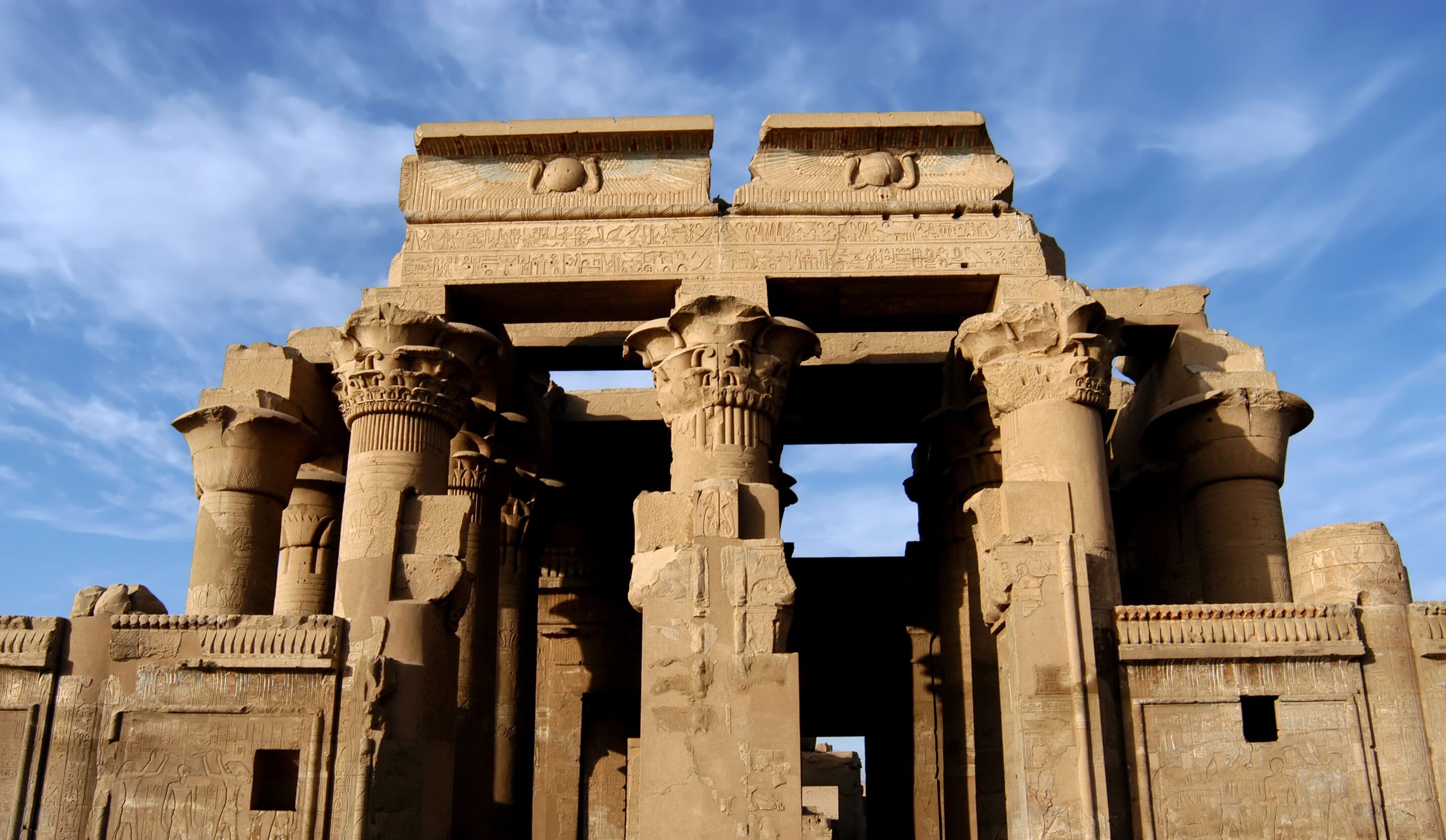 Ancient Egyptian temple columns with hieroglyphs.