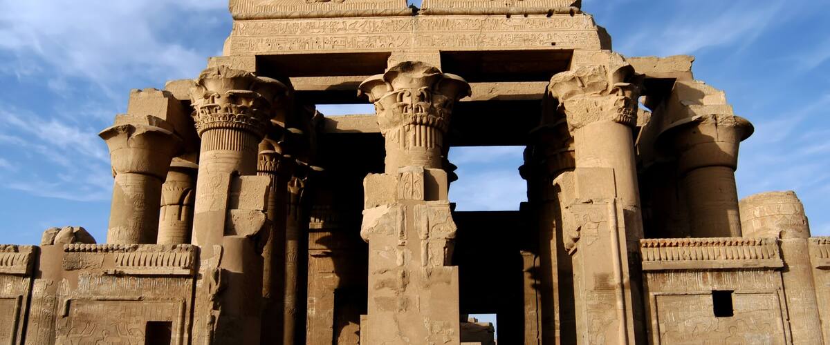 Ancient Egyptian temple columns with hieroglyphs.