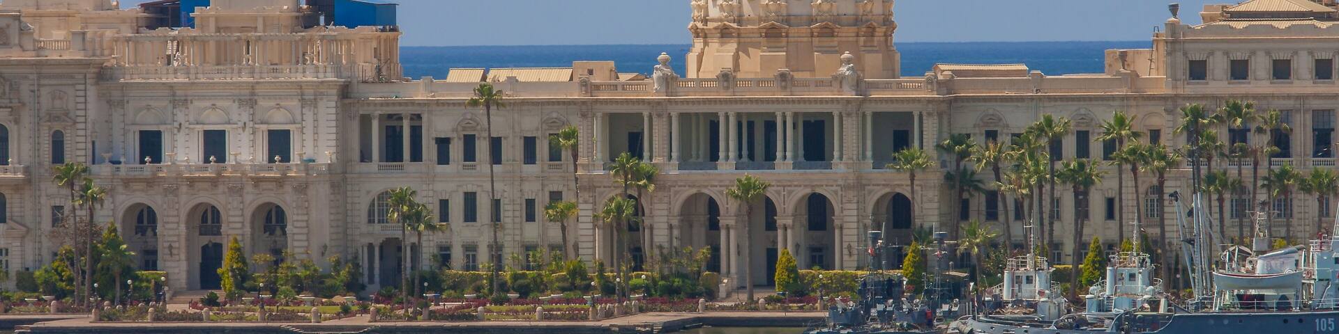 A large neoclassical building with a prominent dome and a waterfront.