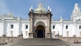 A grand entrance with a large archway, steps leading up to it, and statues on either side.