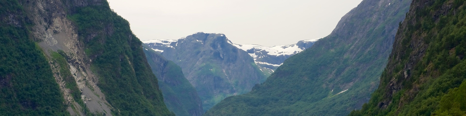 Naeroyfjord which includes mountains and a lake or waterhole