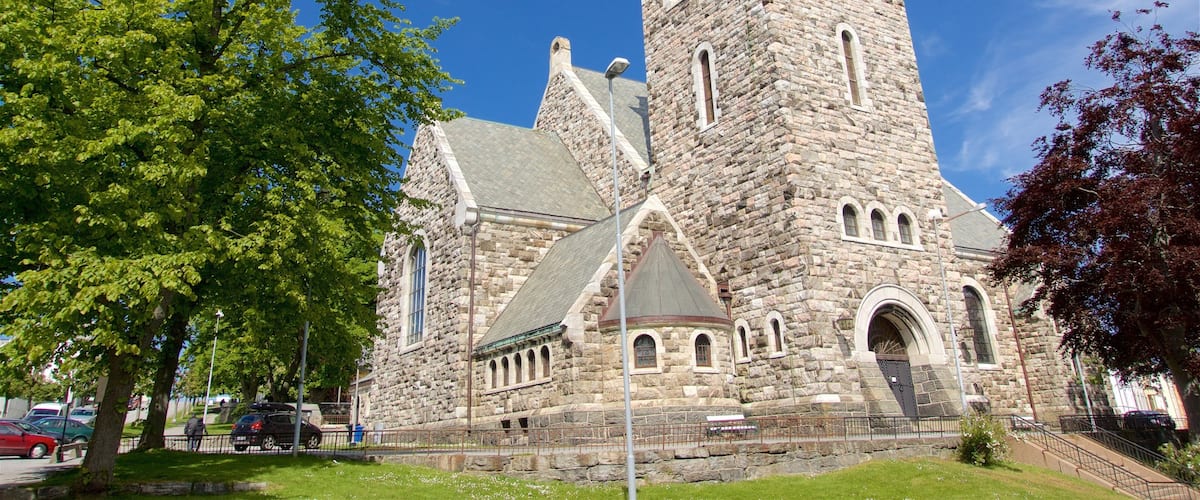 A historic stone church with a prominent tower and arched windows.