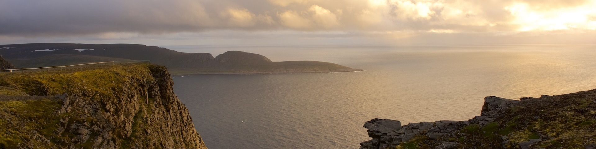 Knivskjellodden showing a lake or waterhole and a sunset