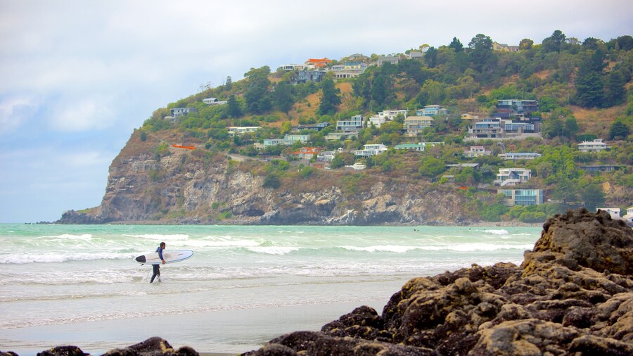 Sumner Beach featuring surfing, a coastal town and rugged coastline