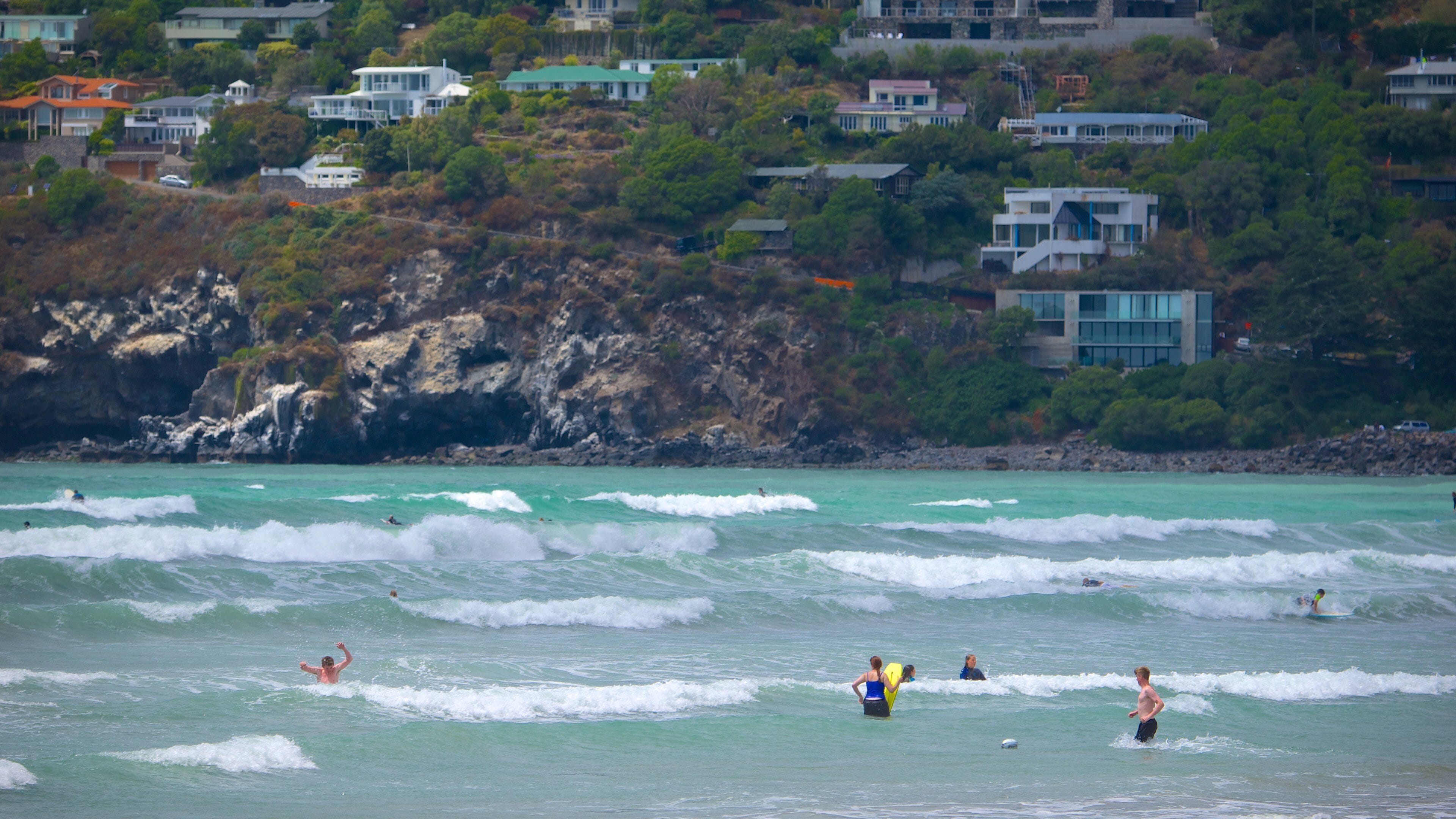 Sumner Beach which includes swimming, a coastal town and waves