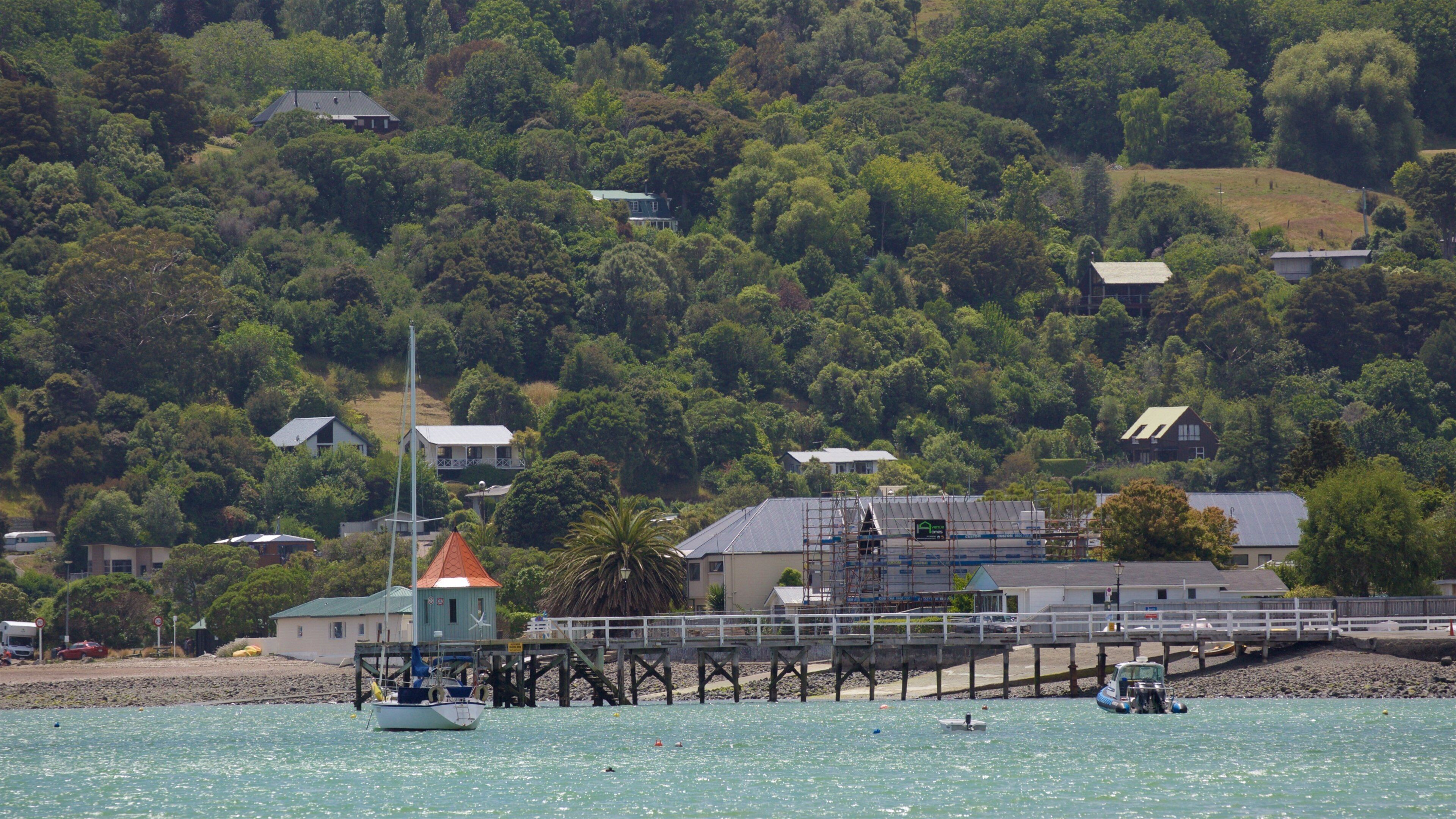 Akaroa Wharf which includes sailing, a coastal town and a bay or harbor