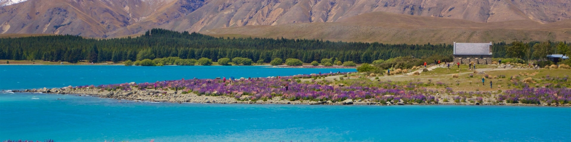 Church of the Good Shepherd mostrando montañas, un lago o espejo de agua y escenas tranquilas