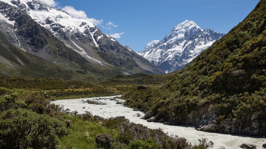 Fast flowing river with Mount Cook in the distance at Aoraki Mount Cook national park, New Zealand
