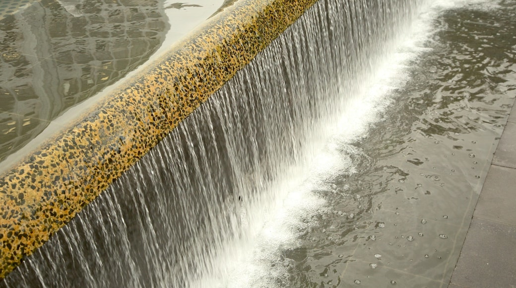The Octagon featuring a waterfall and a pond