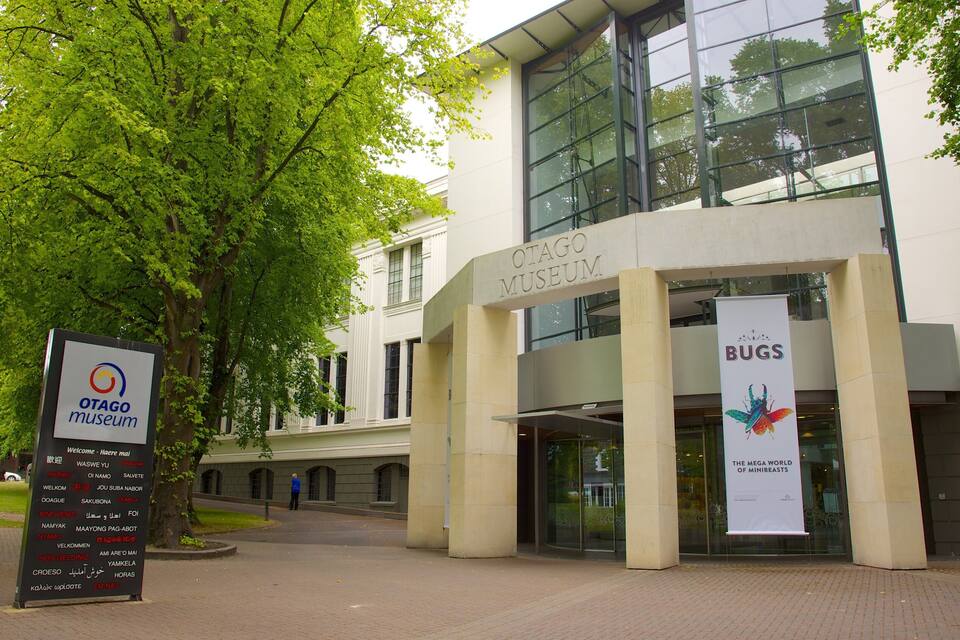 The Otago Museum building with a sign for the Bugs exhibition.