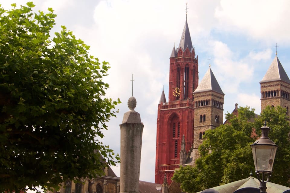 A historic church with a prominent clock tower and spires.