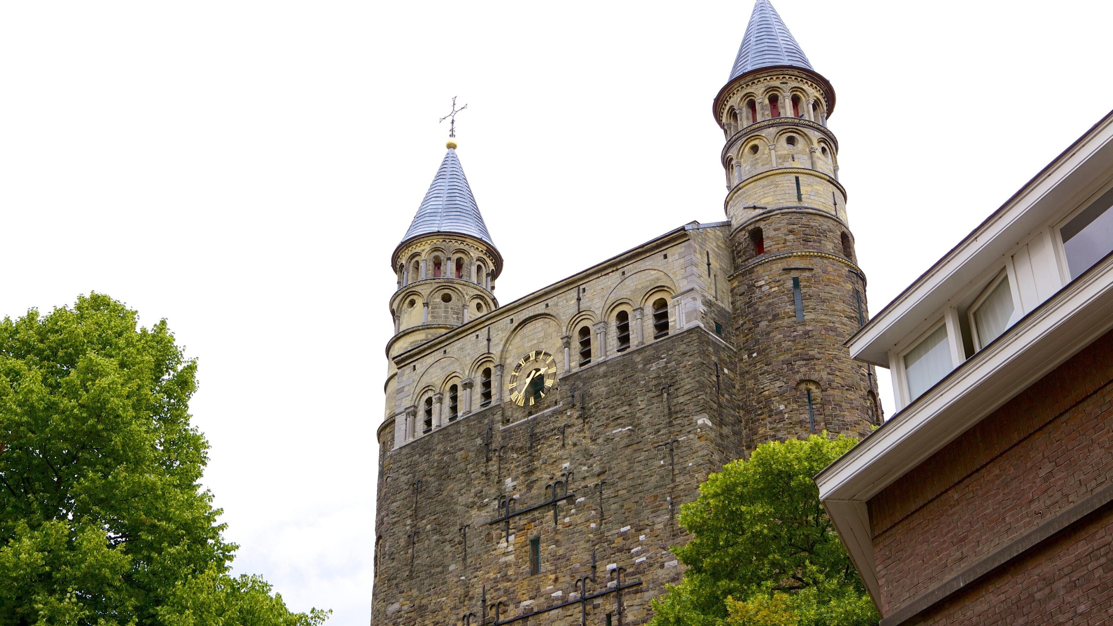 A historic building with two prominent towers and a clock.