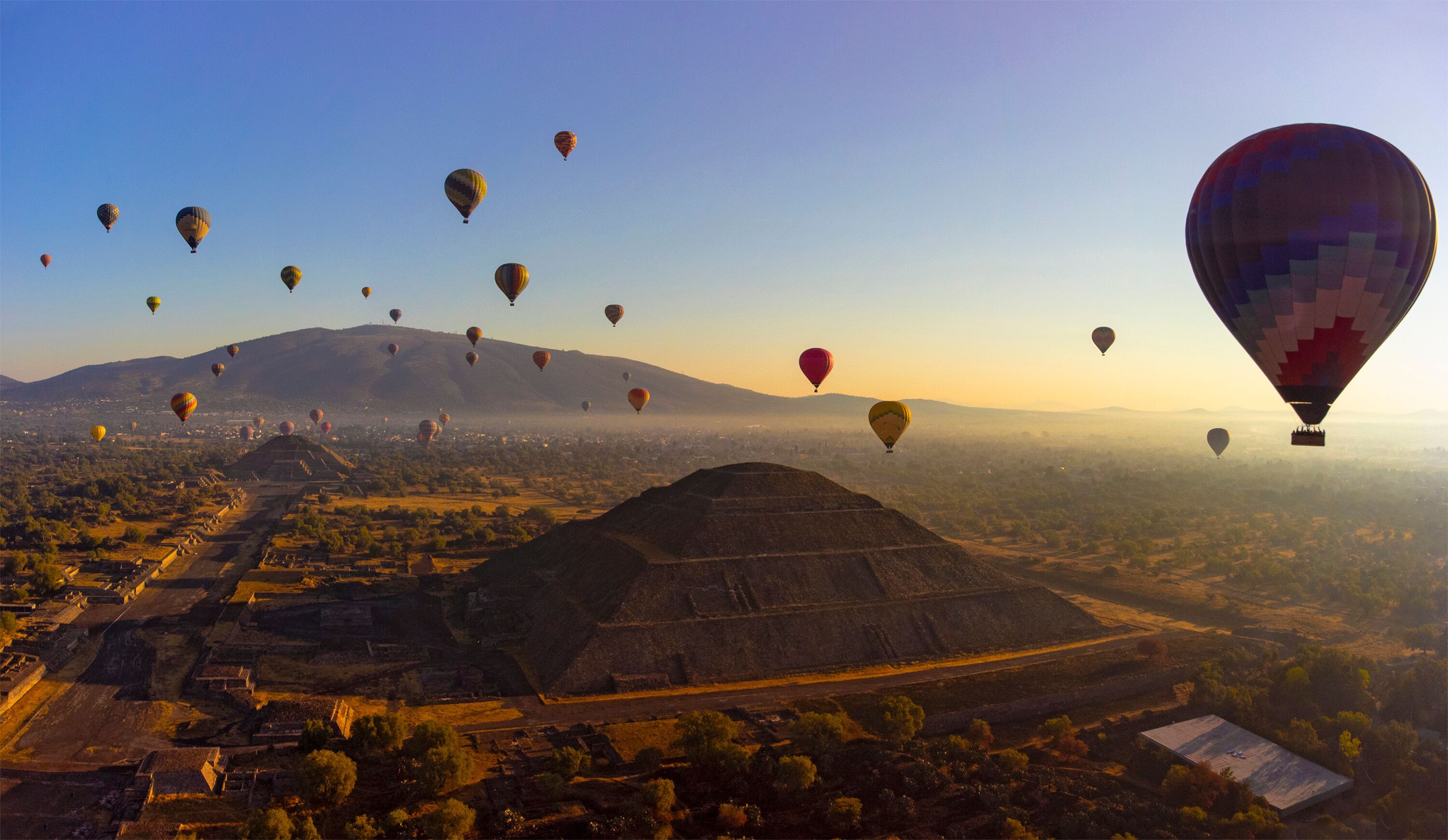 Sunrise on hot air balloon over the Teotihuacan pyramid