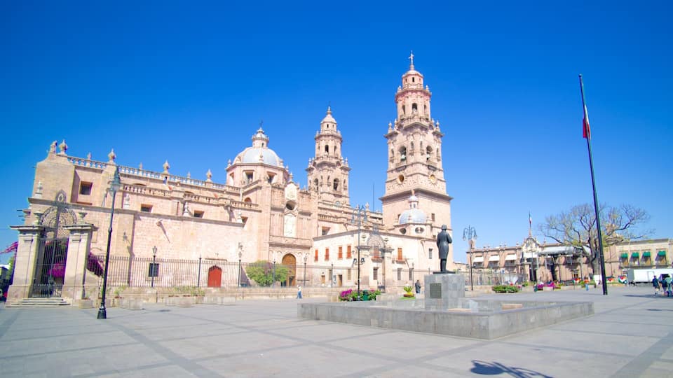 A historic cathedral with two prominent towers and a large plaza in front.