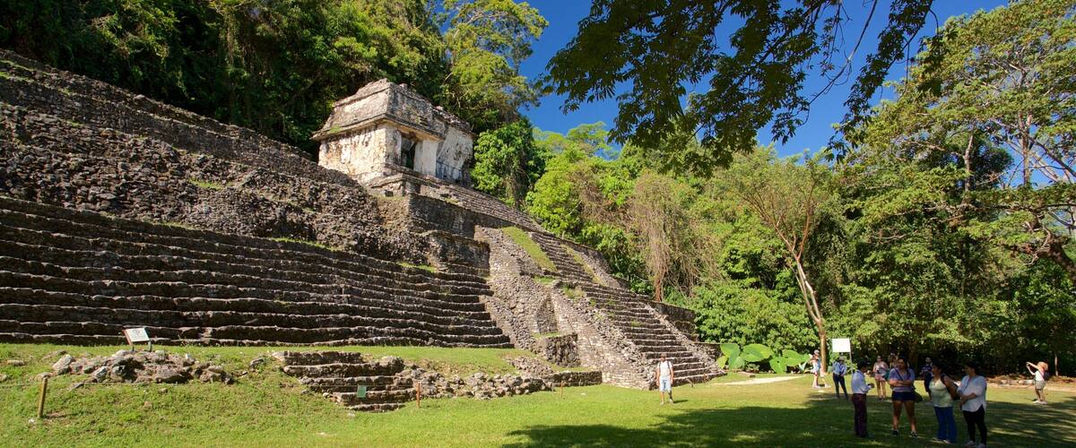 Pre-Hispanic City and National Park of Palenque featuring heritage architecture as well as a small group of people