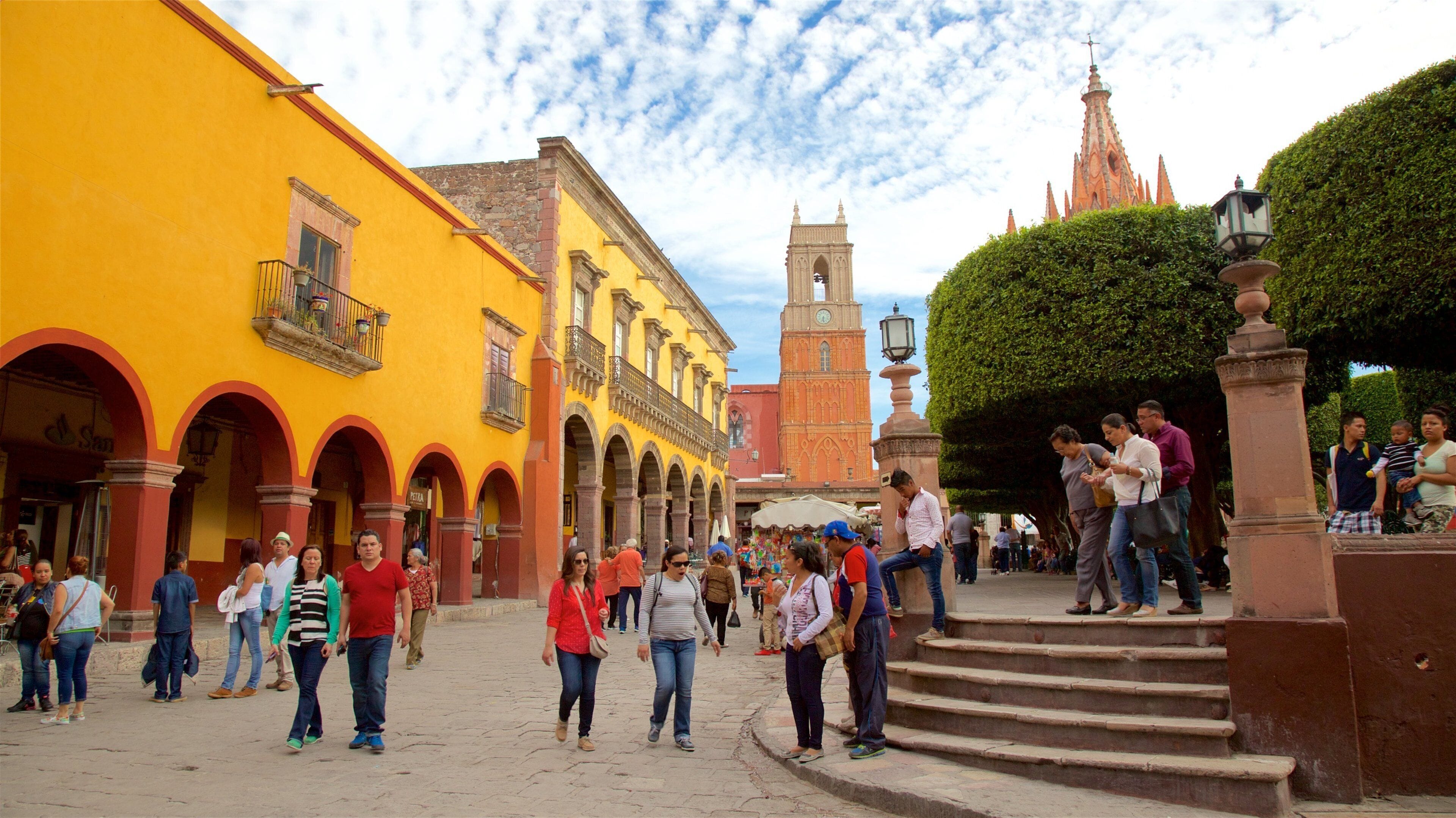 El Jardin showing a church or cathedral and a square or plaza as well as a small group of people