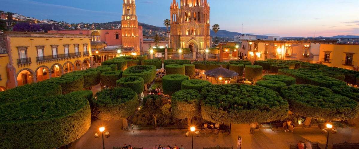 Church of San Miguel Arcángel which includes a garden, a sunset and heritage architecture