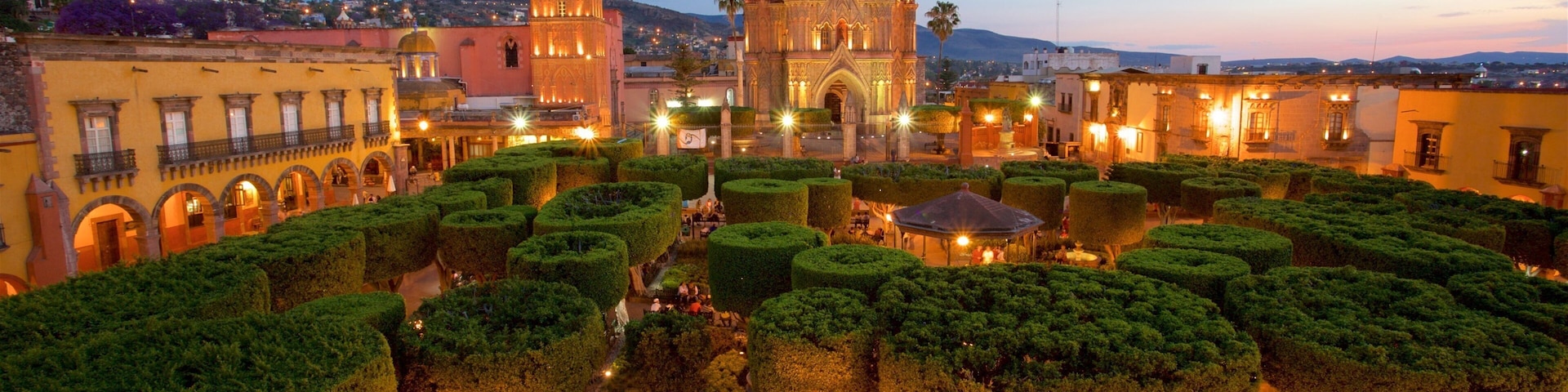 Church of San Miguel Arcángel which includes a garden, a sunset and heritage architecture