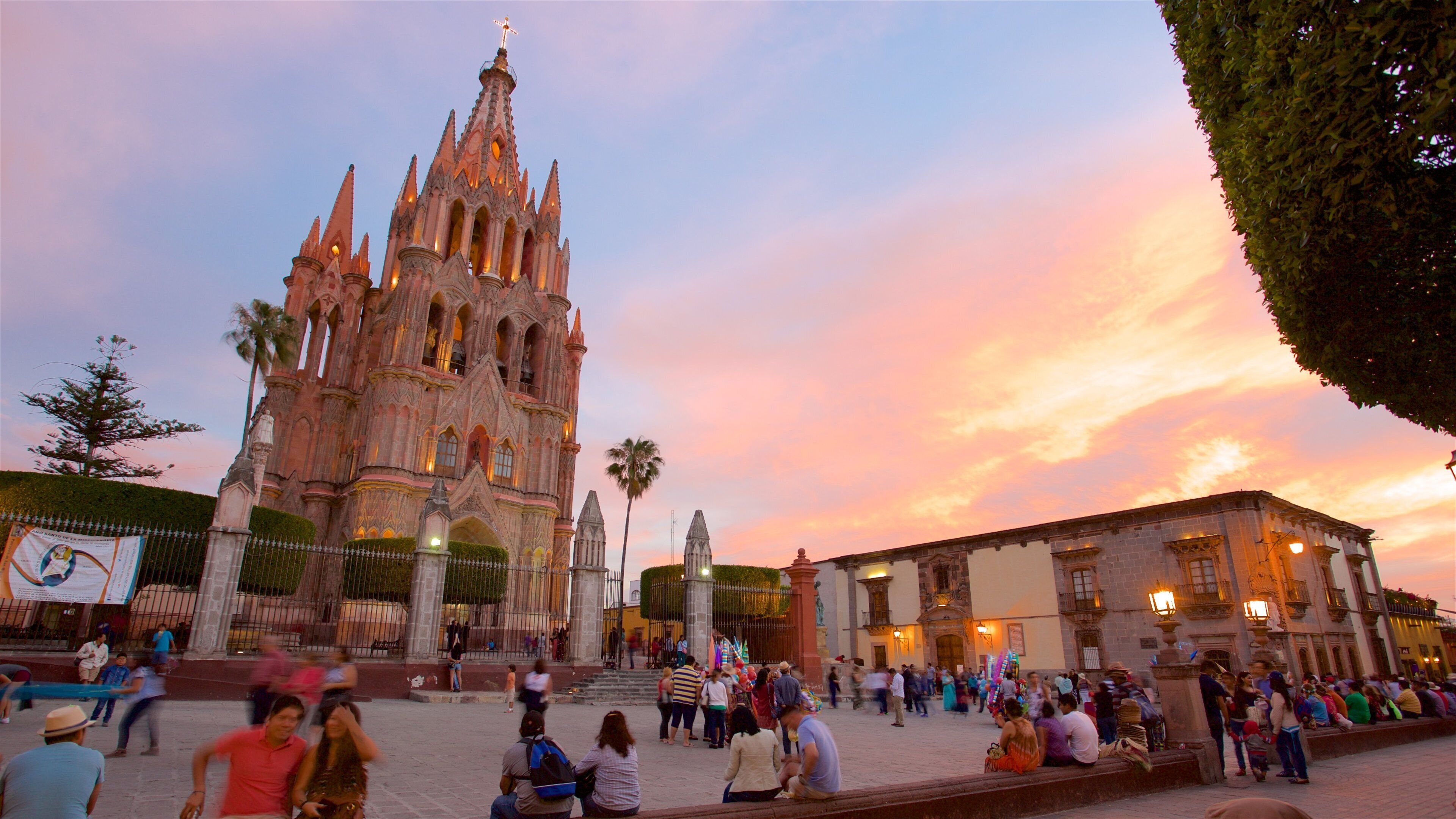 Parish Church of San Miguel Arcangel which includes a church or cathedral, heritage architecture and a sunset