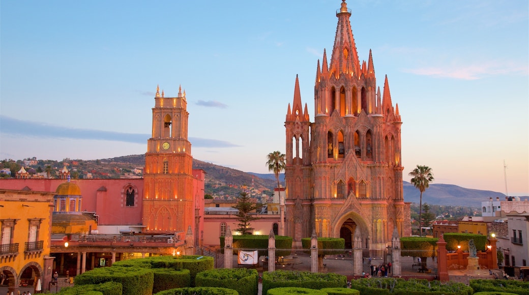 Parish Church of San Miguel Arcangel featuring a sunset, heritage architecture and a garden