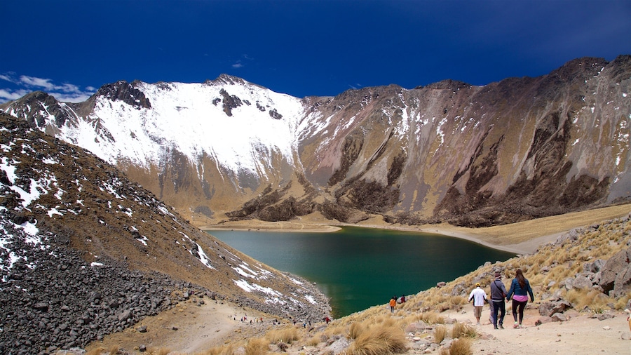 Nevado de Toluca National Park which includes a lake or waterhole and hiking or walking as well as a small group of people