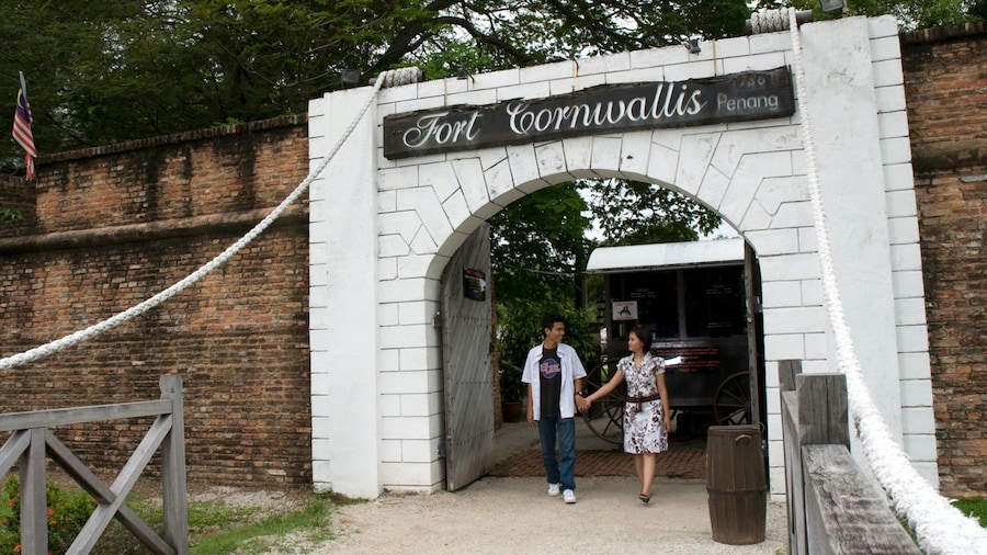 Fort Cornwallis showing heritage architecture and signage as well as a couple