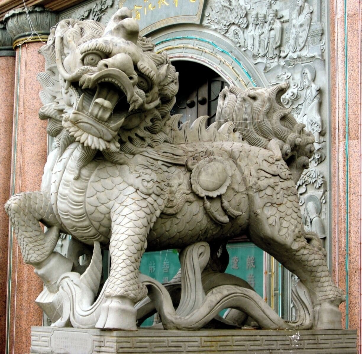 Una detallada escultura de león de piedra en la entrada de un edificio.
