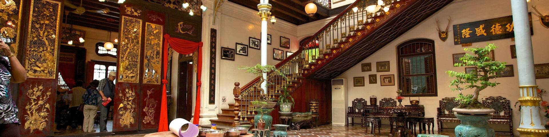 An ornate interior with a staircase, traditional furniture, and decorative elements.