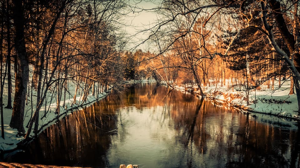 Winter view from the stone walking bridge of the Flint River in the Richfield County Park, Genesee County Parks and Recreation Richfield Township MI