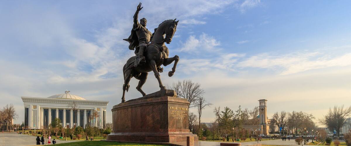 Statue of Tamerlane and Palace of Forums in center of Tashkent at sunset, Uzbekistan
