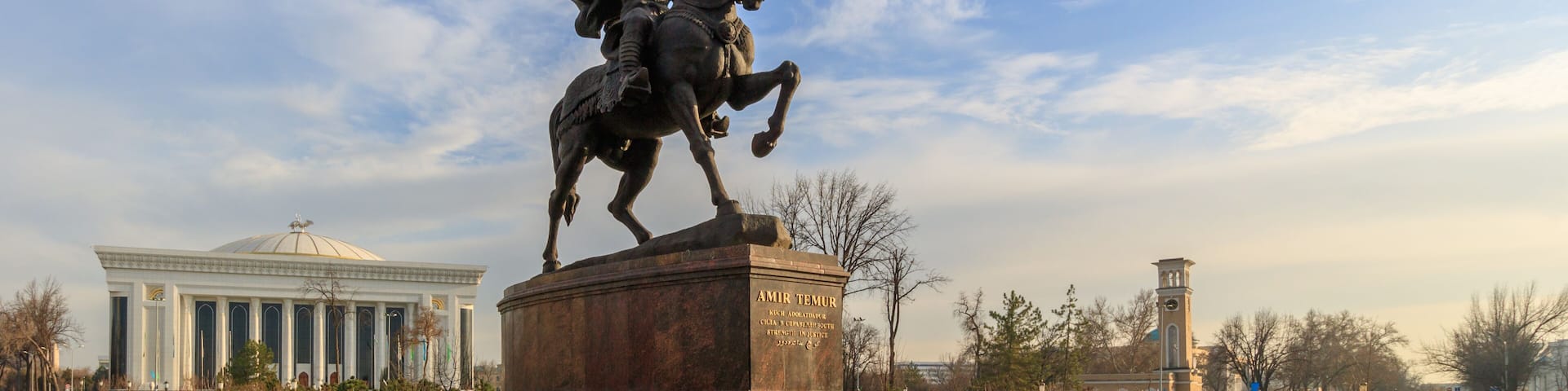 Statue of Tamerlane and Palace of Forums in center of Tashkent at sunset, Uzbekistan