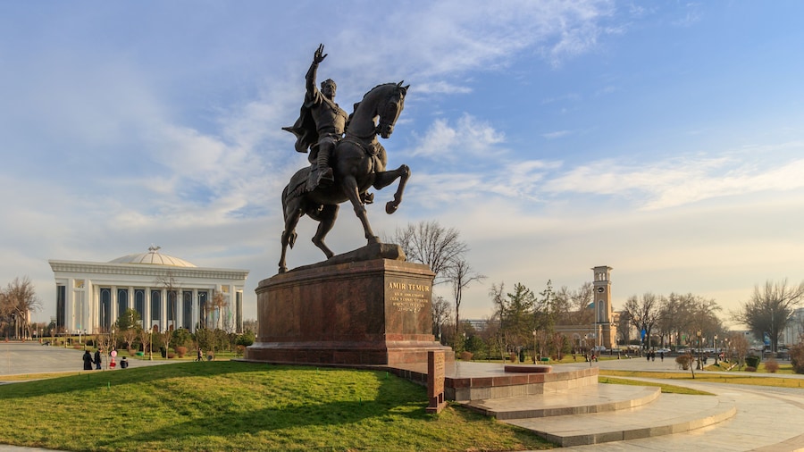 Statue of Tamerlane and Palace of Forums in center of Tashkent at sunset, Uzbekistan