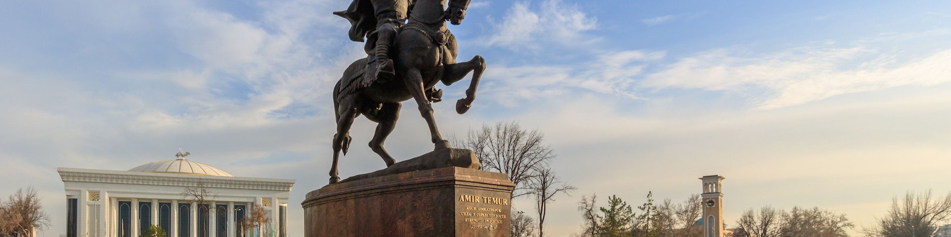 Statue of Tamerlane and Palace of Forums in center of Tashkent at sunset, Uzbekistan