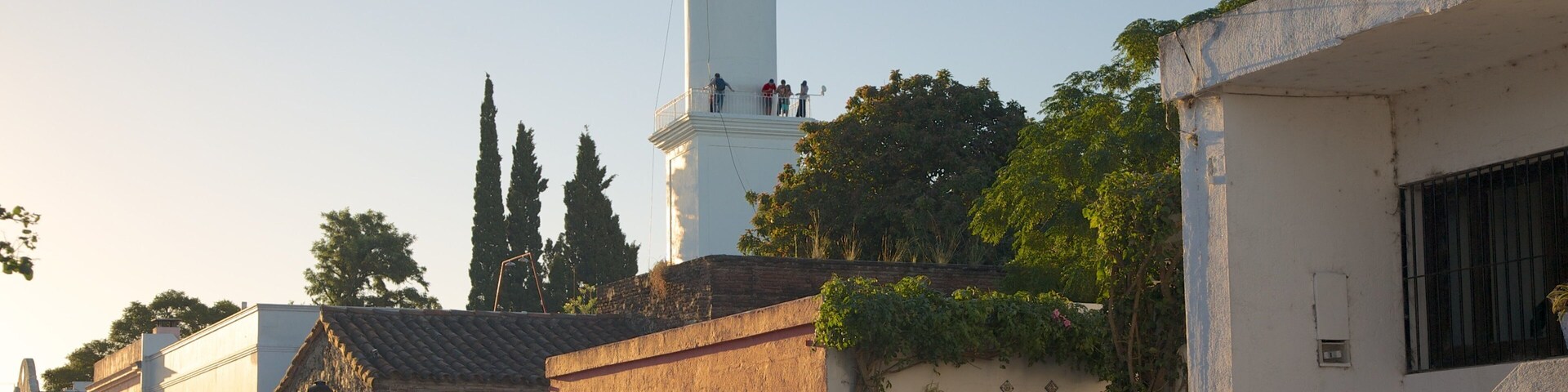Colonia del Sacramento Lighthouse which includes heritage architecture, a lighthouse and a sunset