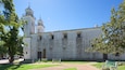 A historic building with a bell tower and a large arched doorway.