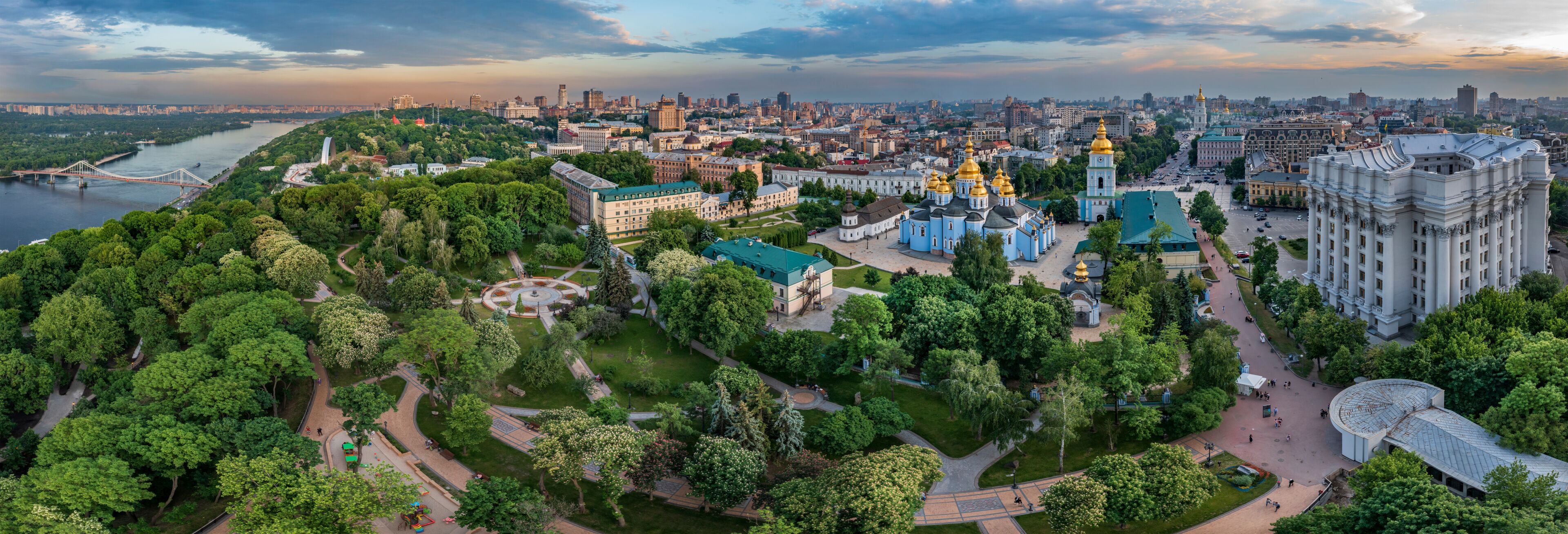 Panorama of Kyiv with a beautiful view of the center of the capital and the Dnieper River at sunset on a summer day, Ukraine. Aerial view.