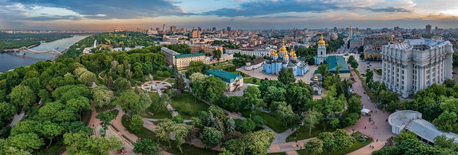 Panorama of Kyiv with a beautiful view of the center of the capital and the Dnieper River at sunset on a summer day, Ukraine. Aerial view.